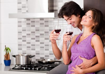 honeymoon couple drinking wine in kitchen