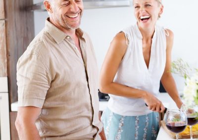 Old couple in the kitchen preparing salad