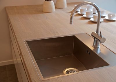 Details of modern design trendy  kitchen sink with water tap faucet
