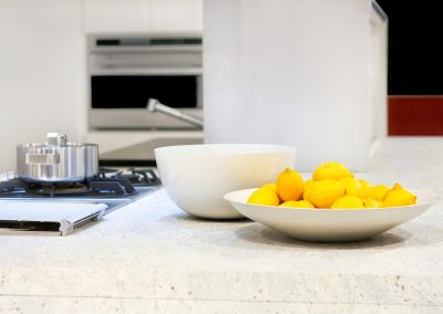 Yellow lemons in bowl at kitchen counter